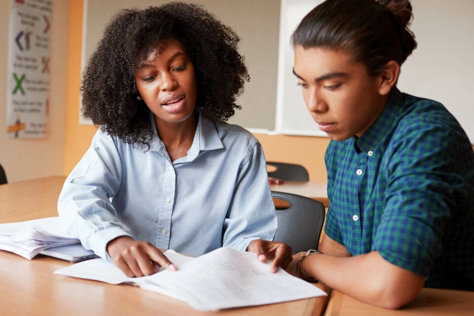 teacher helping student with applications